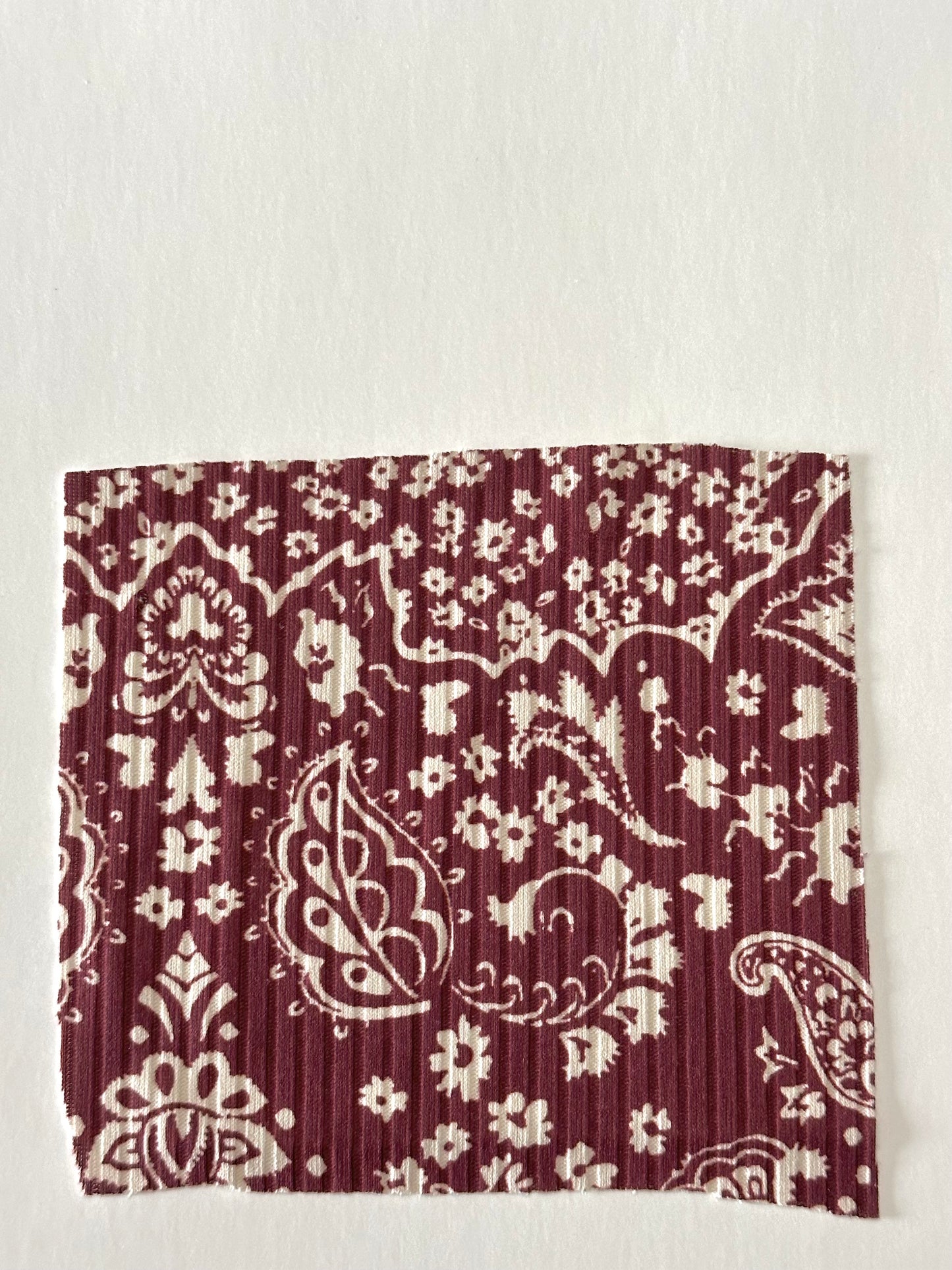 Paisley Toss in Burgundy on Unbrushed Rib Knit Fabric Sold by the 1/4 yard